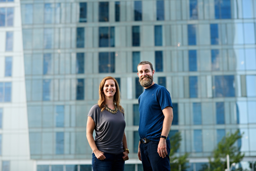 A corporate portrait of a man and woman in front of a building in Philadelphia.
